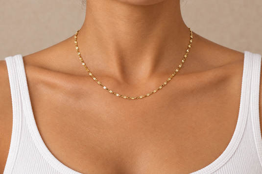 Aliana 2mm gold PVD stainless steel flat lip chain worn as a permanent necklace