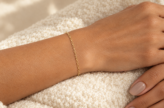 Celeste 2.15mm gold PVD stainless steel textured cable chain worn as a welded permanent bracelet