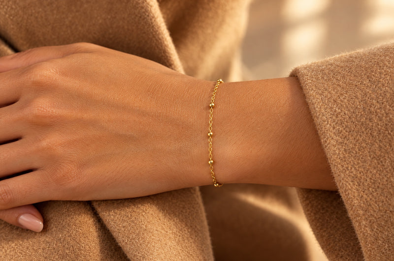 Load image into Gallery viewer, Elee 2.5mm gold PVD stainless steel beaded satellite chain worn as a welded permanent bracelet
