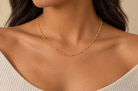Elee 2.5mm gold PVD stainless steel beaded satellite chain worn as a permanent necklace
