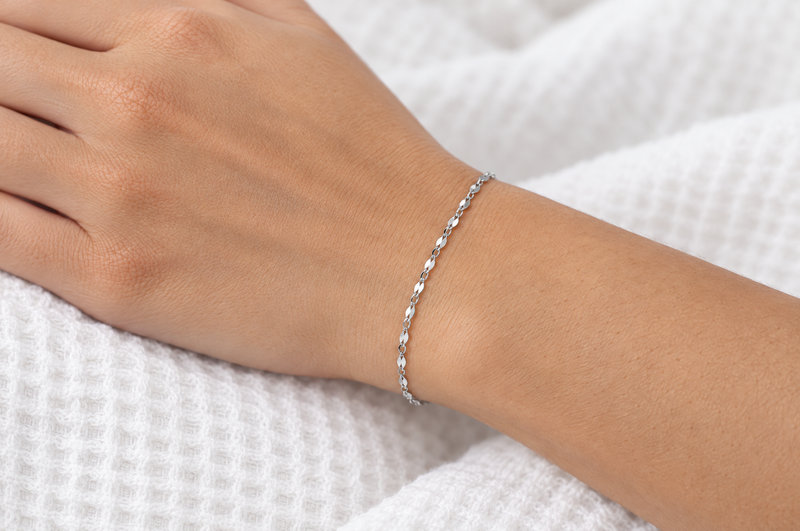Load image into Gallery viewer, Elenor 2mm silver-tone stainless steel flat lip chain worn as a welded permanent bracelet
