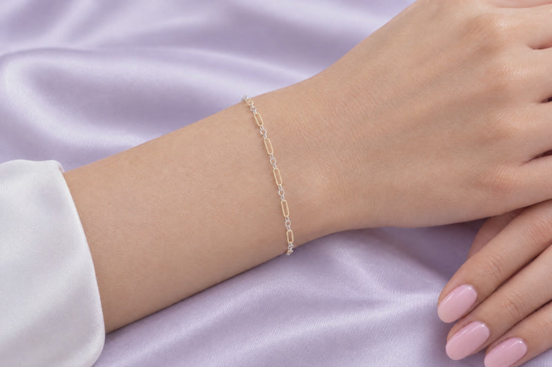 Load and play video in Gallery viewer, Luciana mixed metal chain, 14K gold filled textured paperclip and sterling silver links, worn as a welded permanent bracelet, video
