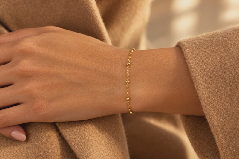 Load and play video in Gallery viewer, Elee 2.5mm gold PVD stainless steel beaded satellite chain worn as a welded permanent bracelet, video
