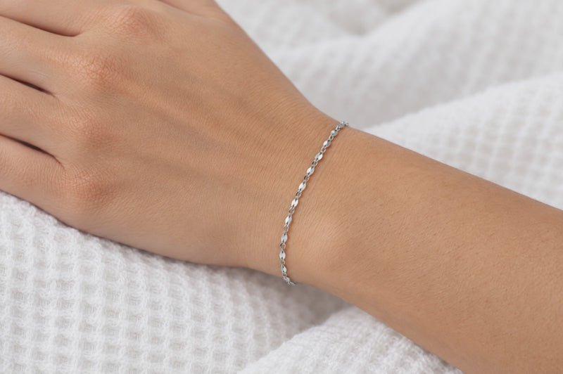 Load and play video in Gallery viewer, Elenor 2mm silver-tone stainless steel flat lip chain worn as a welded permanent bracelet, video
